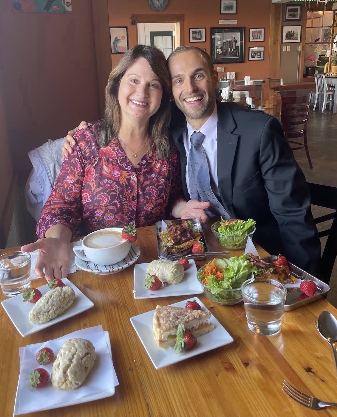 Nina Delores Smith and Nathanael smiling together over a meal.
