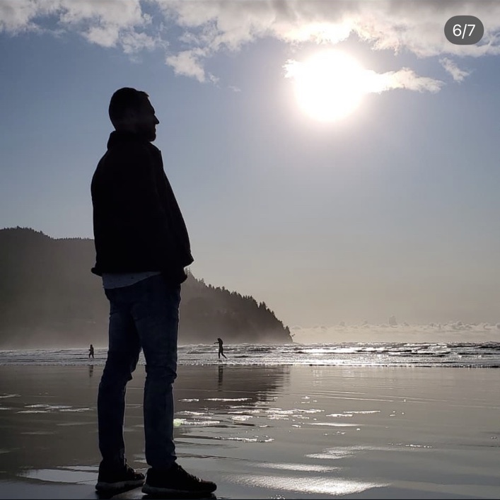 Nathanael standing on Seaside Beach in the sunshine.