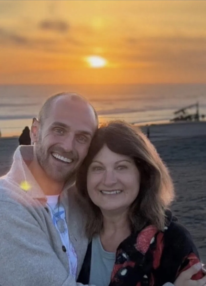 Nathanael and Nina Delores Smith together at the beach at sunset.