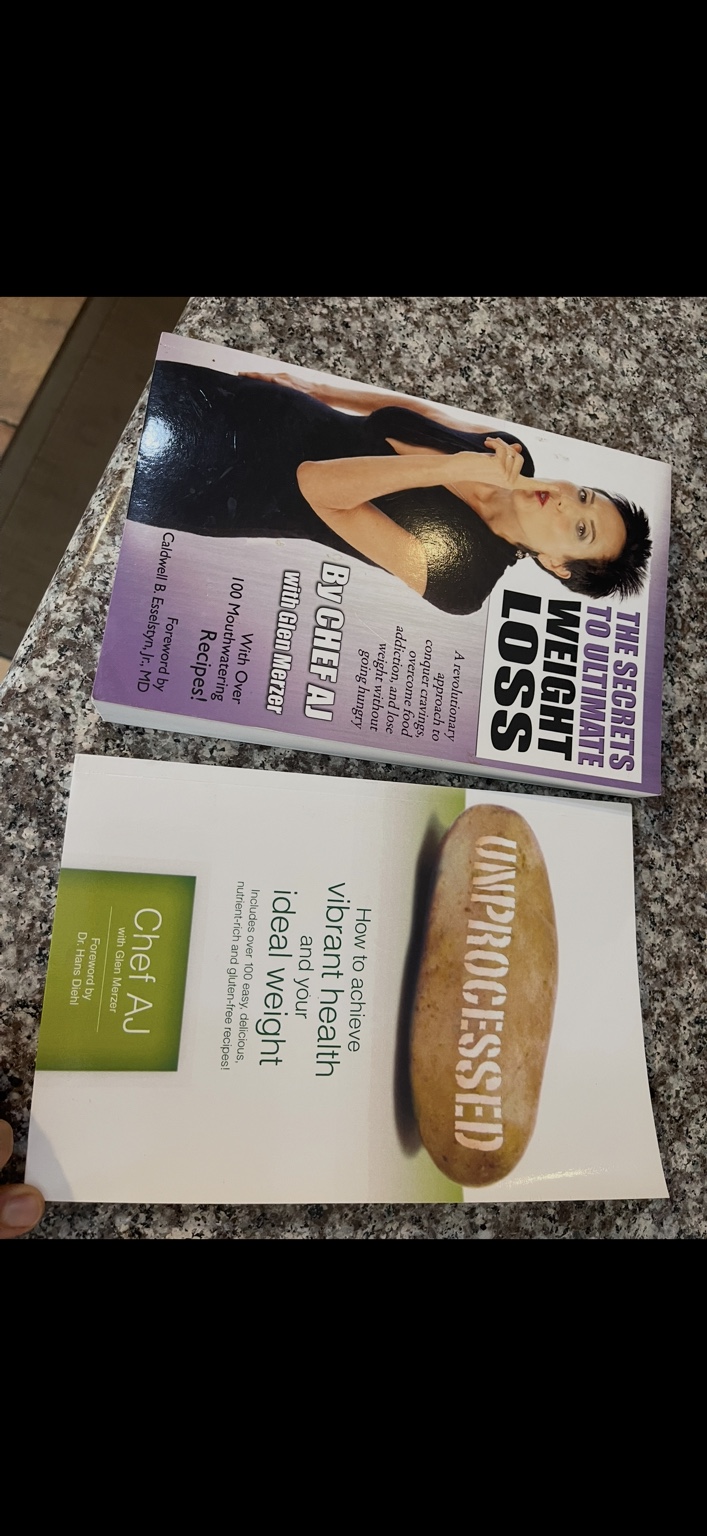 Copies of The Secrets to Ultimate Weight Loss and Unprocessed by Chef AJ.