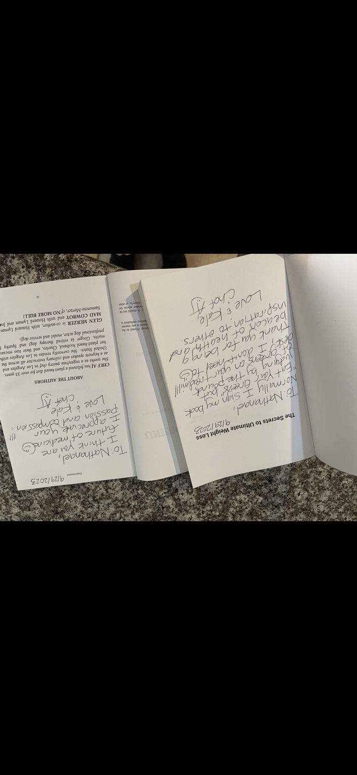 Open copies of Chef AJ’s books showing handwritten inscriptions to Nathanael.