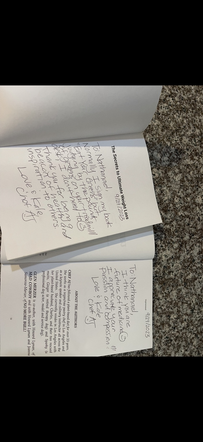 Close view of handwritten inscriptions in two Chef AJ books.