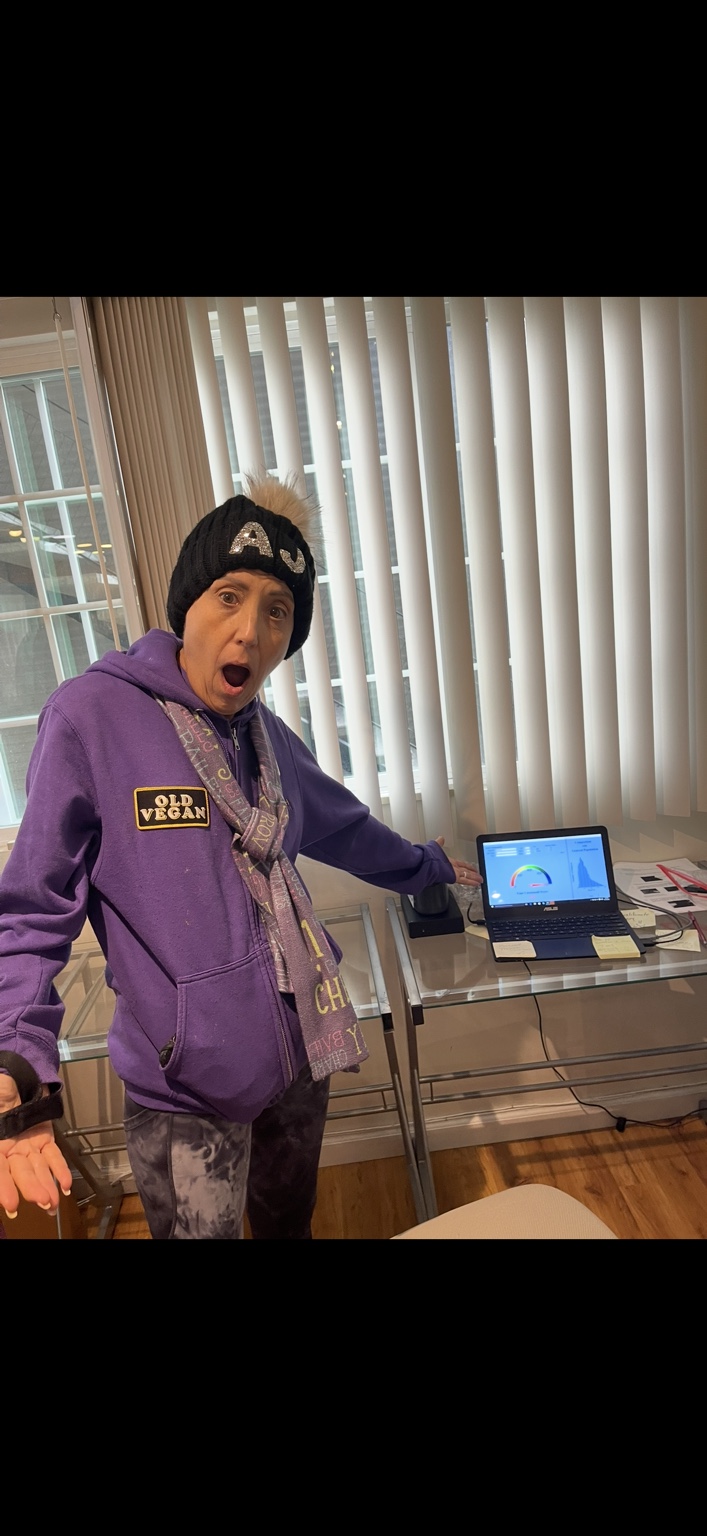 Chef AJ standing beside the carotenoid scanner display with an animated surprised expression.