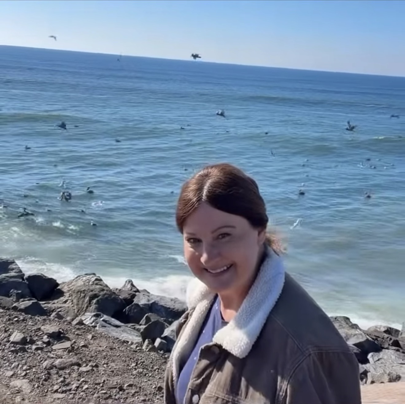 Nina Delores Smith smiling beside the ocean at the South Jetty.